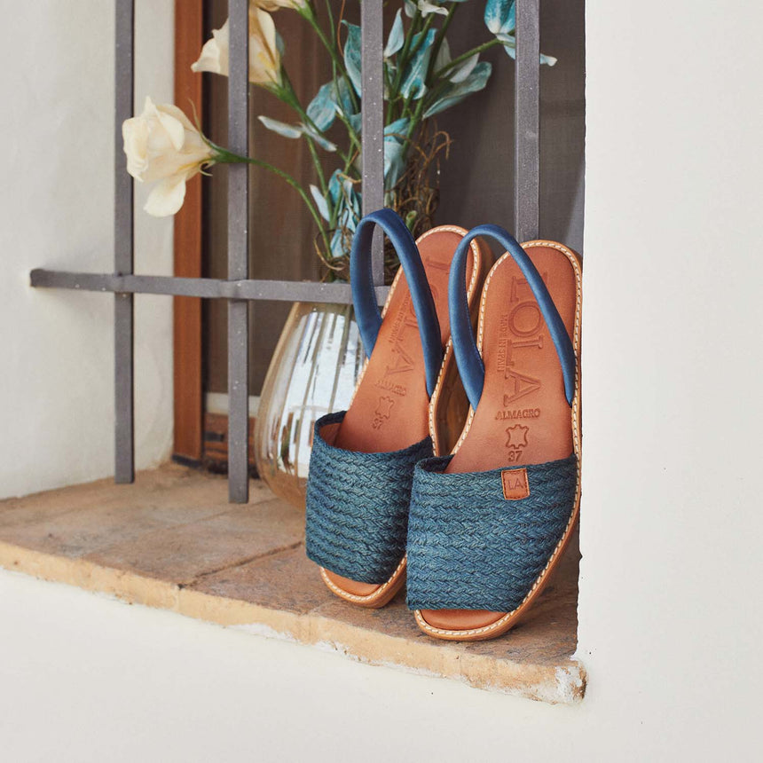 Menorquinas planas de piel con pala de color jeans en una ventana vista desde el ángulo frontal